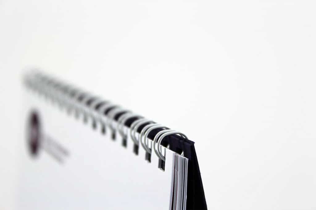 Printed Wiro-bound brand guidelines for ACT - tent card calendar style - showing close-up of Wiro-binding at the head